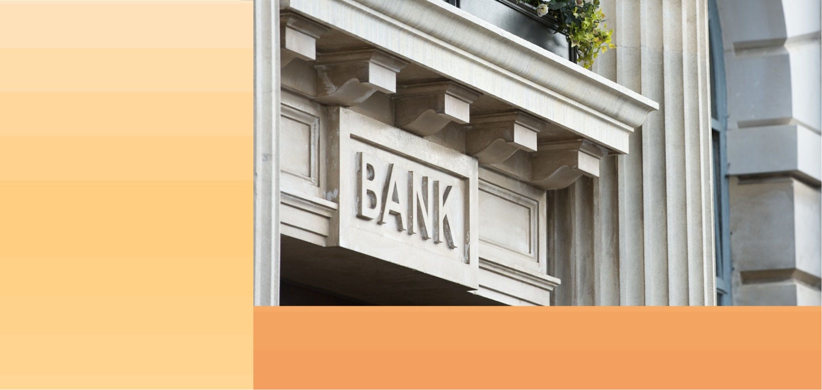 Close up of a bank sign above a neo-classical style entryway